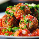 Close-up spicy Moroccan-influenced lamb (kefta) meatball tagine.