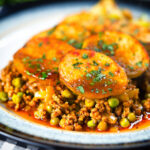 Minced lamb (keema) and potato hotpot with Indian-influenced flavours served with cabbage poriyal.
