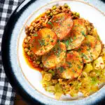 Overhead minced lamb (keema) and potato hotpot with Indian-influenced flavours served with cabbage poriyal.