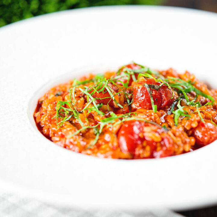 Spicy nduja sausage and tomato risotto with basil chiffonade.