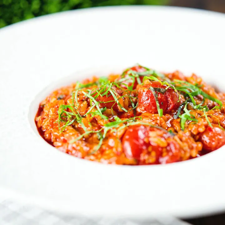 Spicy nduja sausage and tomato risotto with basil chiffonade.
