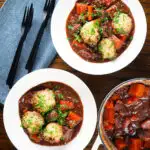 Overhead rich red wine and port venison stew or casserole with suet dumplings.