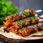 Chicken tikka kebab skewers served with chapati, raita and kachumber salad.