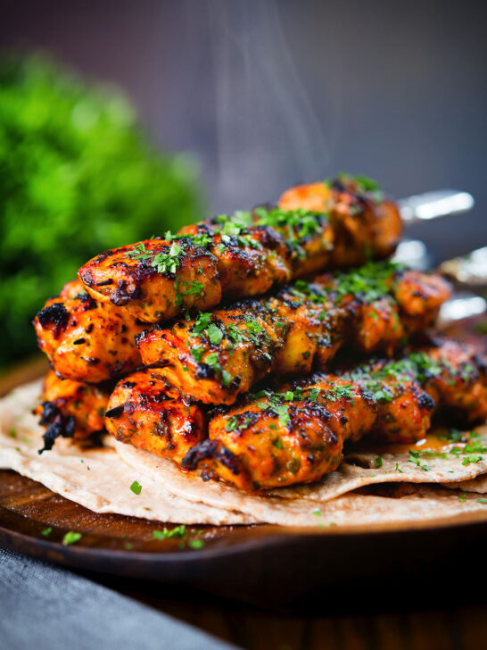Chicken tikka kebab skewers served with chapati, raita and kachumber salad.