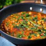 Vegetarian chickpea and parsnip curry in a cooking pan.