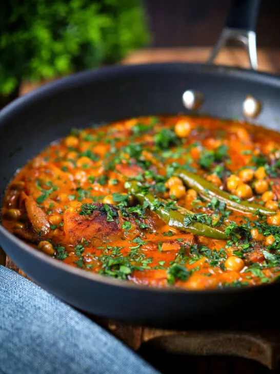 Vegetarian chickpea and parsnip curry in a cooking pan.