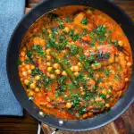 Overhead vegetarian chickpea and parsnip curry in a cooking pan.
