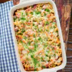 Overhead corned beef and tomato macaroni pasta bake with a cheesy topping.