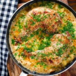 Overhead Somerset chicken cooked in a cider, cheddar cheese and cream sauce served in a pan.