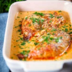 Dijon chicken leg or poulet Gaston Gerard in a gratin dish.
