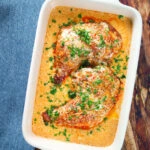 Overhead Dijon chicken leg or poulet Gaston Gerard in a gratin dish.