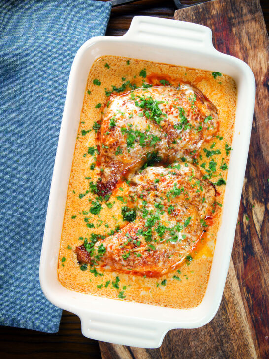 Overhead Dijon chicken leg or poulet Gaston Gerard in a gratin dish.