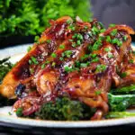 Close-up honey and mustard glazed sausages with mashed potato and tenderstem broccoli.