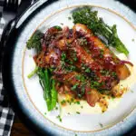 Overhead honey and mustard glazed sausages with mashed potato and tenderstem broccoli.