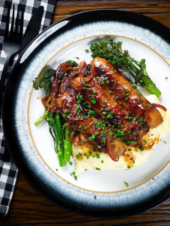 Overhead honey and mustard glazed sausages with mashed potato and tenderstem broccoli.
