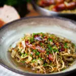 Sausage and lentil stew with cabbage, apples and English mustard served with bread.