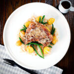 Slow cooker (crock pot) pork chops and sauerkraut with potatoes and green beans.