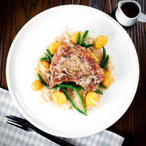 Slow cooker (crock pot) pork chops and sauerkraut with potatoes and green beans.