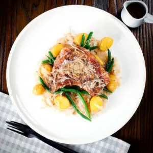 Slow cooker (crock pot) pork chops and sauerkraut with potatoes and green beans.