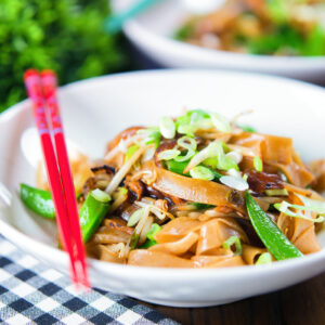 Stir fried ho fun (wide rice) noodles with bean sprouts, shiitake mushrooms and sugar snap peas.