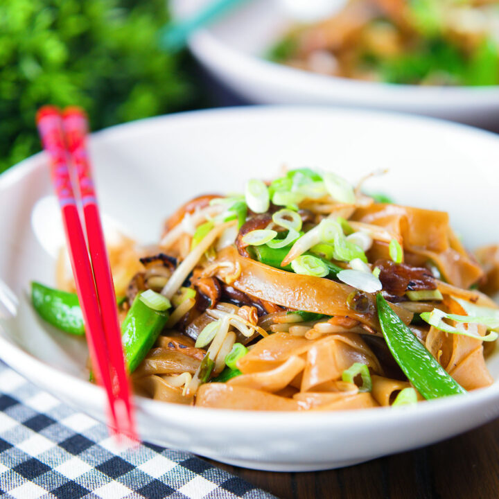 Stir fried ho fun (wide rice) noodles with bean sprouts, shiitake mushrooms and sugar snap peas.