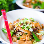 Vegetarian ho fun noodles stir fry with bean sprouts, shiitake mushrooms and sugar snap peas.