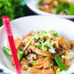 Vegetarian ho fun noodles stir fry with bean sprouts, shiitake mushrooms and sugar snap peas.