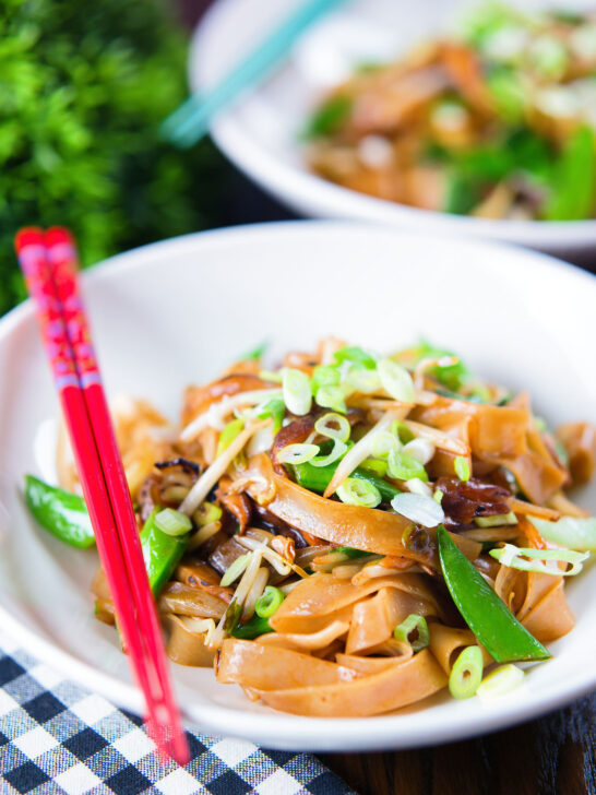 Vegetarian ho fun noodles stir fry with bean sprouts, shiitake mushrooms and sugar snap peas.