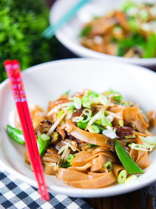 Vegetarian ho fun noodles stir fry with bean sprouts, shiitake mushrooms and sugar snap peas.