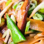 Close-up ho fun noodles stir fry with bean sprouts, shiitake mushrooms and sugar snap peas.