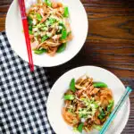Overhead ho fun noodles stir fry with bean sprouts, shiitake mushrooms and sugar snap peas.