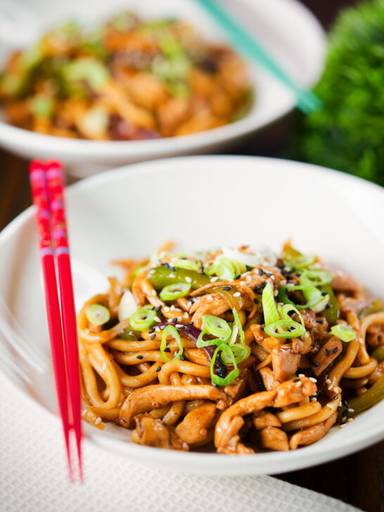 Stir fried teriyaki chicken noodles with spring onions and sesame seeds.