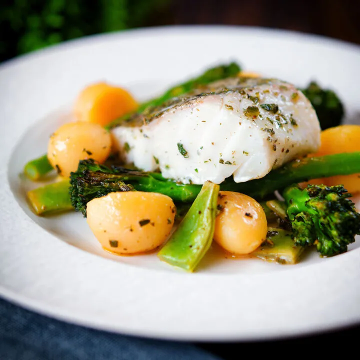 Herby cod traybake with tinned potatoes, tenderstem broccoli and runner beans
