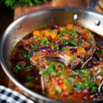 Roasted mango chutney pork chops in a cooking pan.