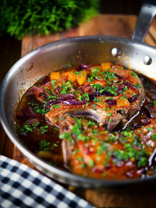 Roasted mango chutney pork chops in a cooking pan.