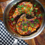 Overhead roasted mango chutney pork chops in a cooking pan.