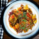 Overhead spicy roasted mango chutney pork chops with Indian influenced roasted Bombay potatoes.