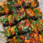 Overhead close-up paneer tikka kebabs served with homemade chapatis.