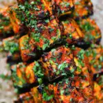 Overhead close-up paneer tikka kebabs served with homemade chapatis.
