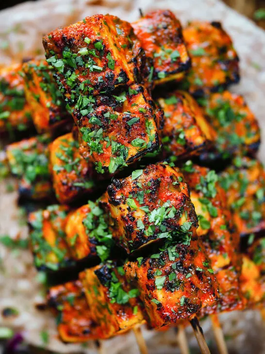 Overhead close-up paneer tikka kebabs served with homemade chapatis.