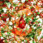 Close-up overhead Greek prawn (shrimp) saganaki with feta cheese.