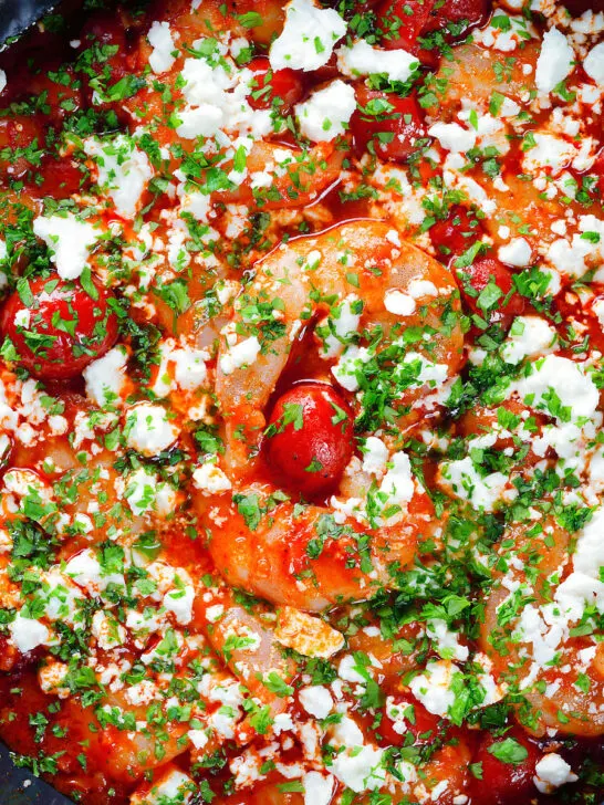 Close-up overhead Greek prawn (shrimp) saganaki with feta cheese.