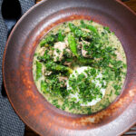 Overhead herby Thai green pork curry with sugar snap peas and jasmine rice.