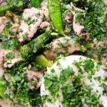 Close-up overhead herby Thai green pork curry with sugar snap peas and jasmine rice.