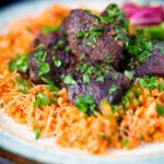 Afelia or Cypriot pork braised in red wine and coriander seeds with pourgouri.