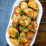 Overhead aloo jeera (Indian spiced cumin potatoes) garnished with fresh coriander.