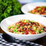 Chinese sausage (lap cheong) and egg fried rice with sweet green peas and spring onion.