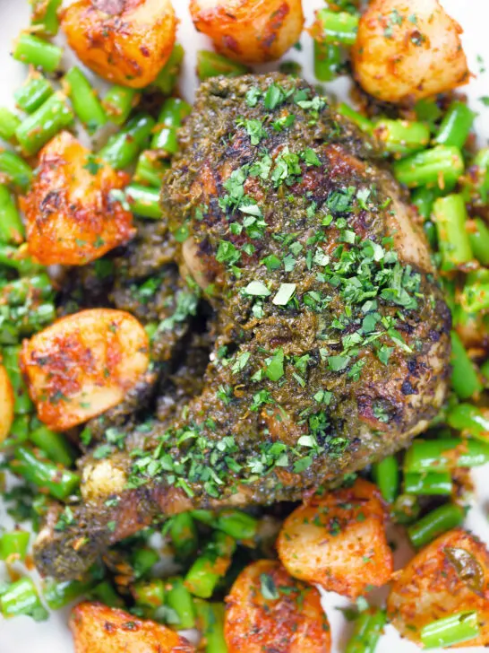Overhead close-up Goan (Indian) Chicken Cafreal served with aloo jeera and green bean poriyal.