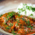 Goan chicken xacuti curry served with white rice and fresh coriander.