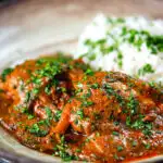 Goan chicken xacuti curry served with white rice and fresh coriander.